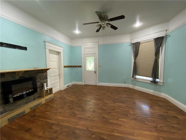 1105 Edgar Ave, Mattoon, IL 61938 - unfurnished living room with a stone fireplace, a ceiling fan, and wood finished floors