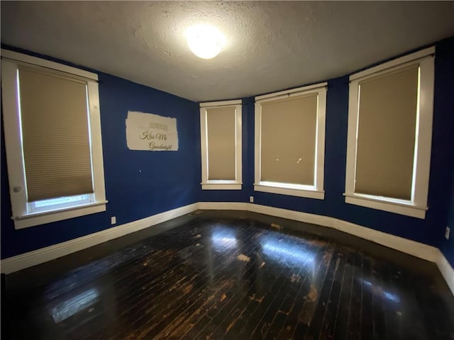 1105 Edgar Ave, Mattoon, IL 61938 - spare room featuring a textured ceiling and hardwood / wood-style flooring