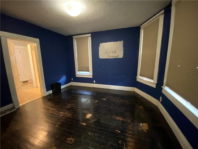 1105 Edgar Ave, Mattoon, IL 61938 - unfurnished bedroom with hardwood / wood-style flooring and a textured ceiling