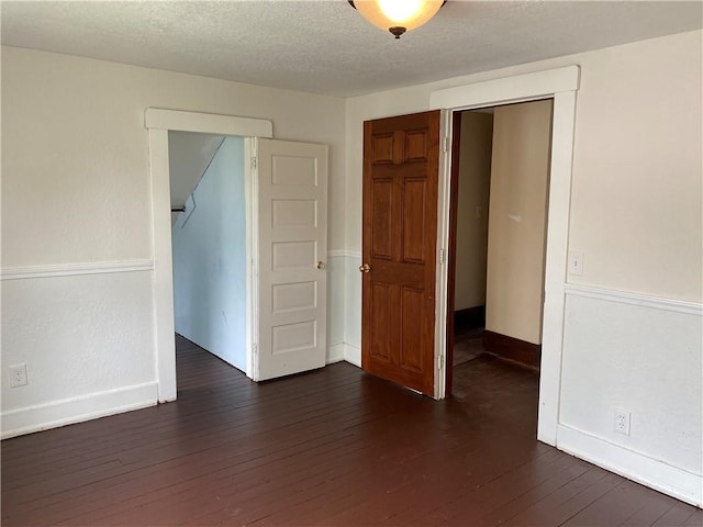 764 10th St, Charleston, IL 61920 - empty room featuring dark wood-style floors and a textured ceiling