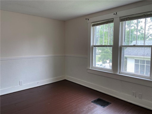 764 10th St, Charleston, IL 61920 - empty room with dark wood-type flooring and baseboards