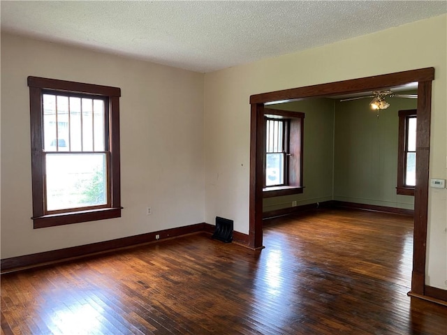 764 10th St, Charleston, IL 61920 - empty room featuring wood finished floors, a textured ceiling, and a ceiling fan