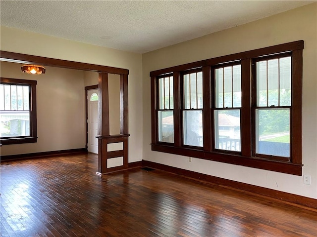 764 10th St, Charleston, IL 61920 - unfurnished room featuring dark wood-style floors and a textured ceiling