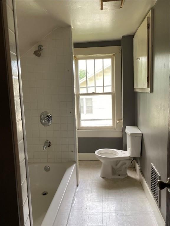 764 10th St, Charleston, IL 61920 - full bathroom with tile patterned floors, washtub / shower combination, and lofted ceiling
