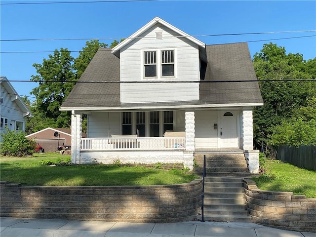 764 10th St, Charleston, IL 61920 - view of front facade featuring covered porch, a front yard, and a shingled roof