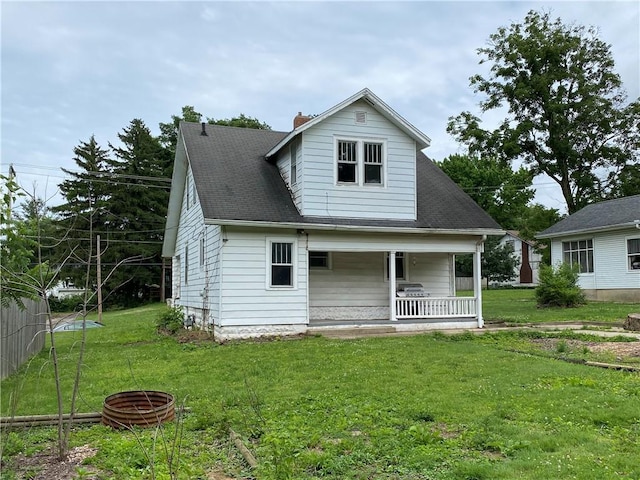 764 10th St, Charleston, IL 61920 - rear view of property featuring covered porch and a yard