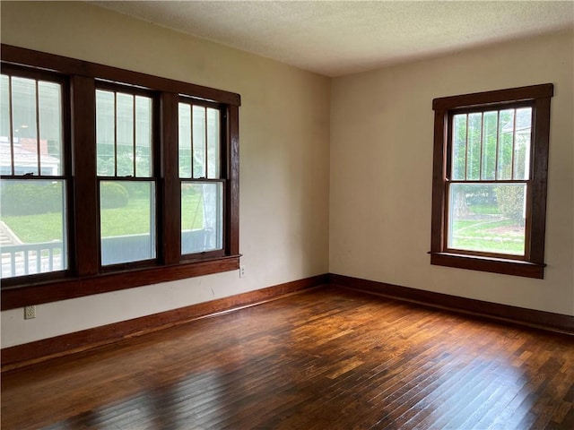 764 10th St, Charleston, IL 61920 - spare room featuring dark wood-style flooring and a textured ceiling