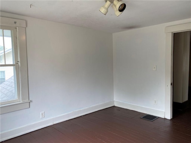 764 10th St, Charleston, IL 61920 - unfurnished room featuring baseboards and dark wood-style flooring