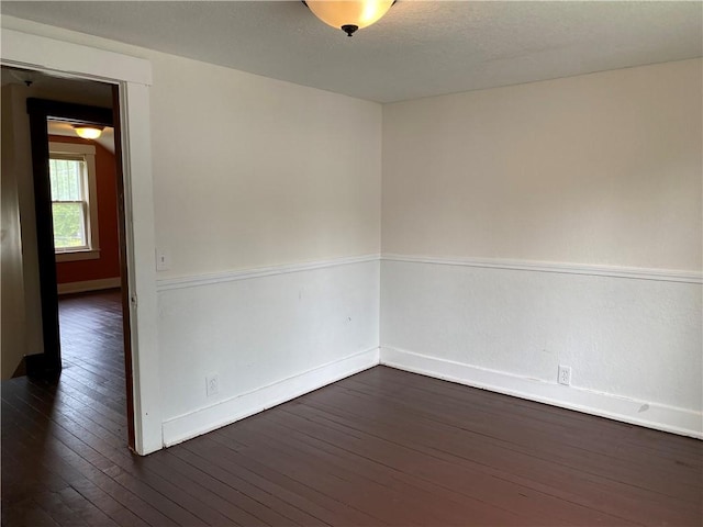 764 10th St, Charleston, IL 61920 - spare room with dark wood-type flooring and baseboards