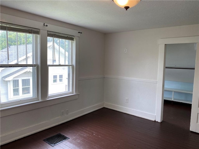 764 10th St, Charleston, IL 61920 - empty room with wood-type flooring and a textured ceiling