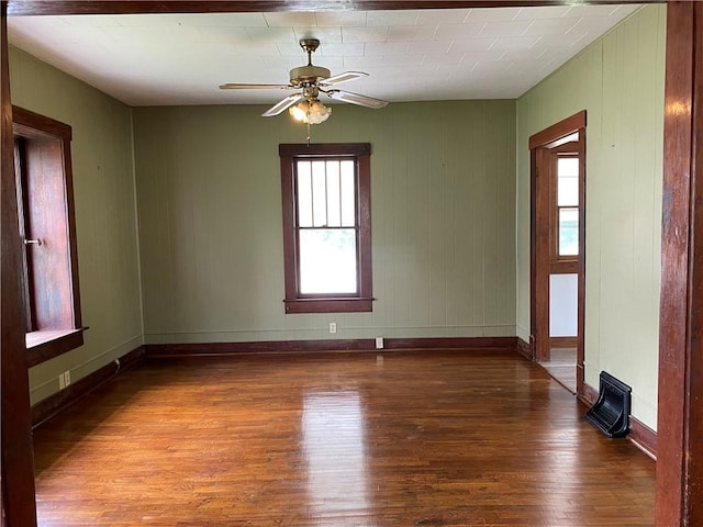 764 10th St, Charleston, IL 61920 - empty room featuring wood finished floors, ceiling fan, and healthy amount of natural light