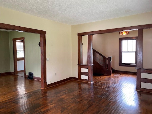 764 10th St, Charleston, IL 61920 - spare room featuring wood-type flooring, stairway, and a textured ceiling