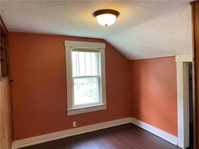 764 10th St, Charleston, IL 61920 - additional living space featuring a textured ceiling, vaulted ceiling, and dark wood finished floors