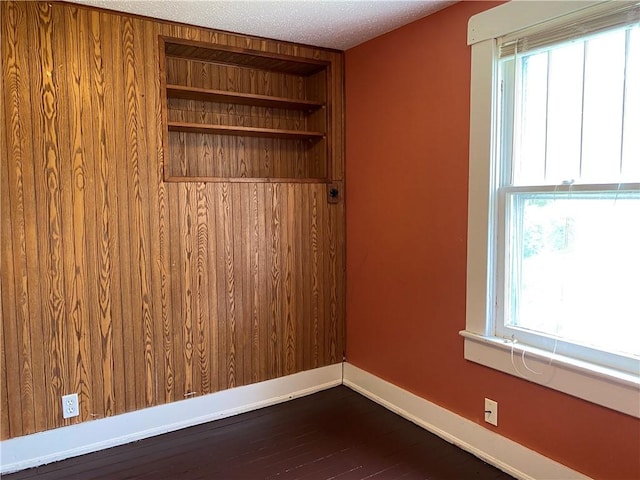 764 10th St, Charleston, IL 61920 - spare room featuring plenty of natural light, dark wood-style flooring, and a textured ceiling
