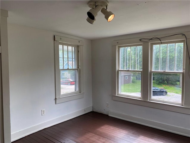 764 10th St, Charleston, IL 61920 - unfurnished room with plenty of natural light and dark wood-style flooring