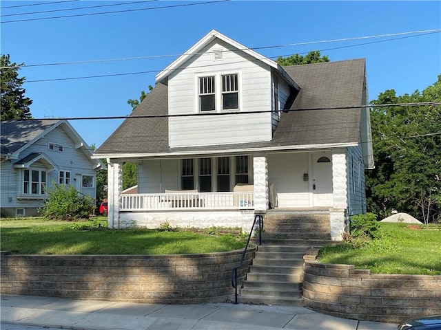 764 10th St, Charleston, IL 61920 - view of front of home featuring a porch, a front lawn, and roof with shingles