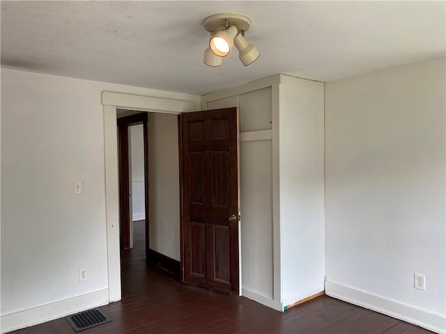 764 10th St, Charleston, IL 61920 - spare room featuring dark wood-style floors and baseboards