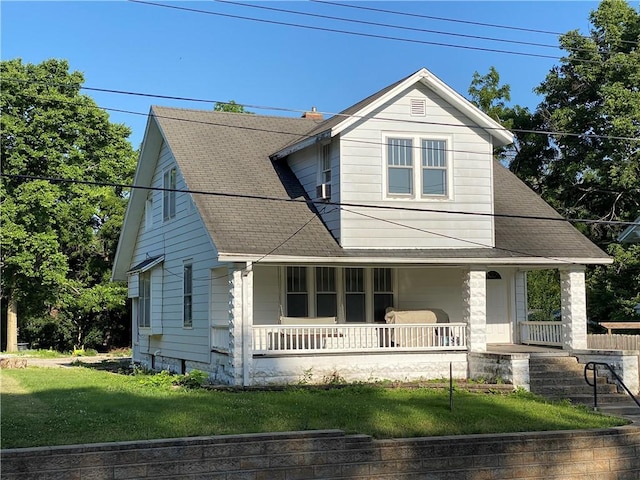 764 10th St, Charleston, IL 61920 - view of front of house with a porch, a front lawn, and a shingled roof