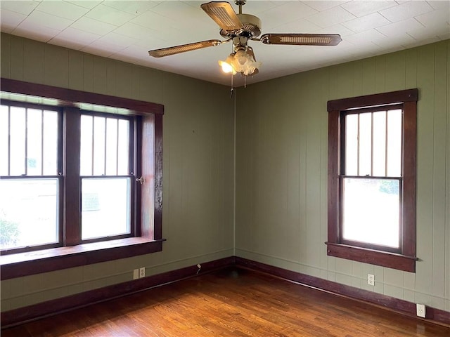 764 10th St, Charleston, IL 61920 - empty room featuring wood finished floors, plenty of natural light, and a ceiling fan