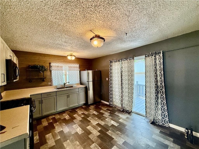 1250 S Lake Ridge Ave, Decatur, IL 62521 - kitchen featuring freestanding refrigerator, black microwave, light countertops, dark wood finished floors, and wood walls