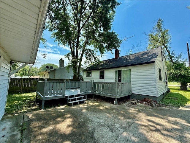 1250 S Lake Ridge Ave, Decatur, IL 62521 - back of house featuring a deck, roof with shingles, and a chimney