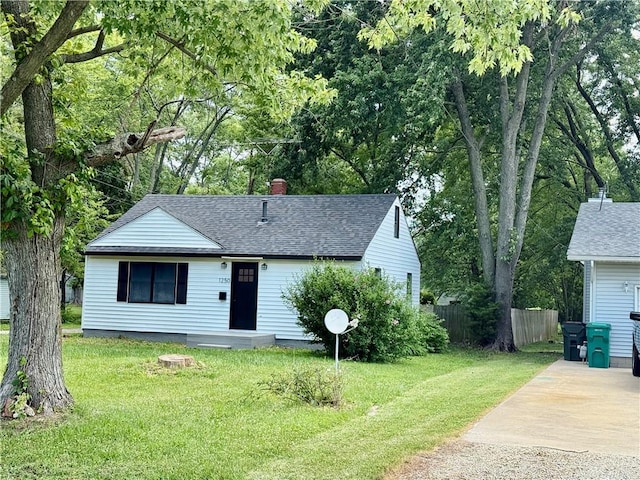 1250 S Lake Ridge Ave, Decatur, IL 62521 - view of front facade featuring a shingled roof, driveway, and a chimney