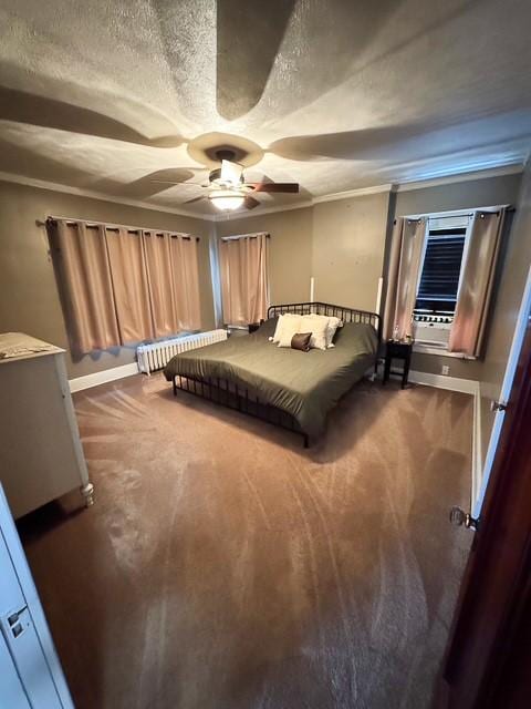 carpeted bedroom featuring a textured ceiling, baseboards, ceiling fan, and radiator