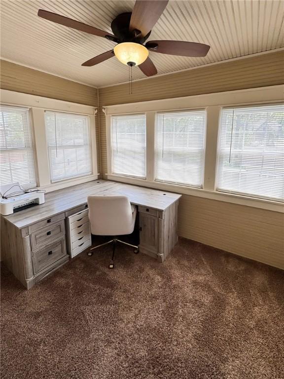 unfurnished office with dark carpet and a ceiling fan