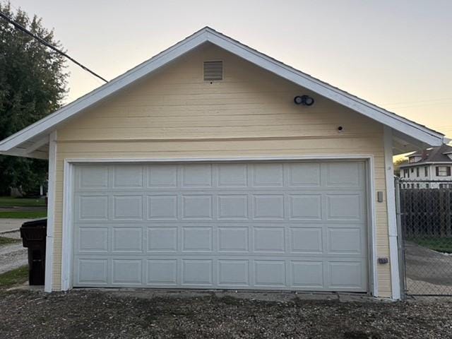 garage at dusk featuring a garage