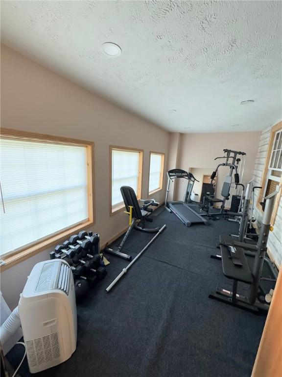 workout area featuring a textured ceiling