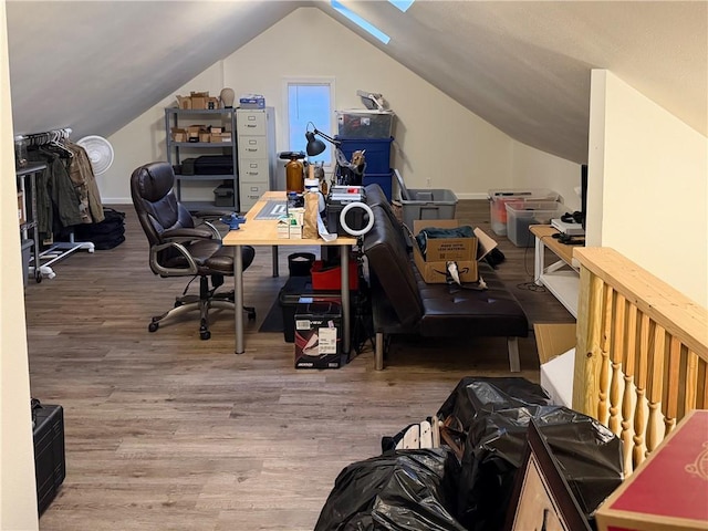 office space featuring vaulted ceiling and wood finished floors
