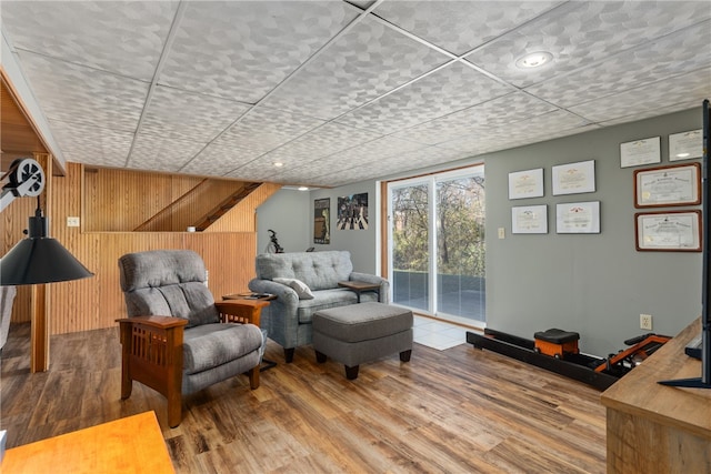 unfurnished room with wood-type flooring and wood walls