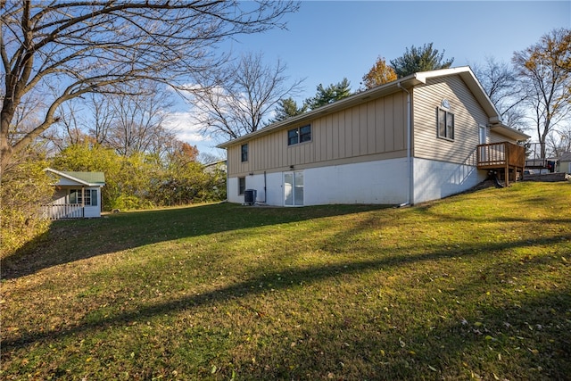 view of home's exterior featuring a yard, a deck, and cooling unit