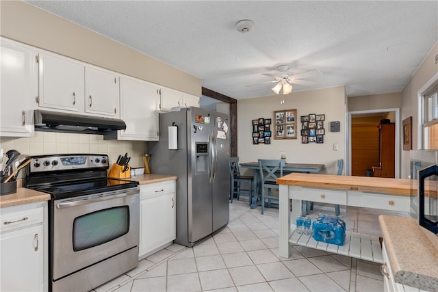 kitchen featuring white cabinets, ceiling fan, a textured ceiling, tasteful backsplash, and stainless steel appliances