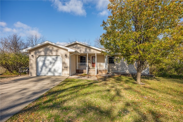 view of front of home featuring a porch, a garage, and a front yard