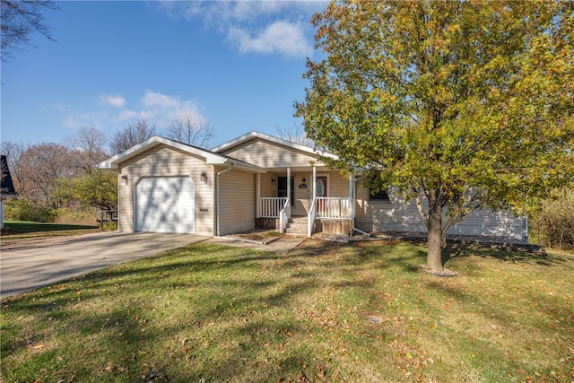 view of front of home featuring covered porch, a garage, and a front lawn