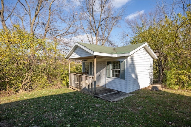 view of property exterior with a lawn and covered porch