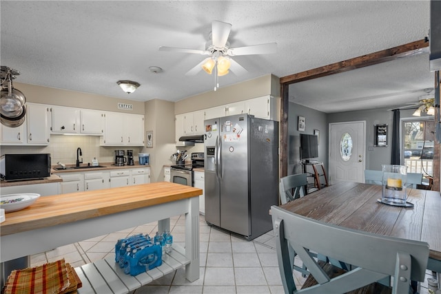 kitchen featuring appliances with stainless steel finishes, backsplash, white cabinetry, and sink