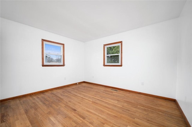 710 E Blackburn St, Paris, IL 61944 - empty room with light wood-style floors and baseboards