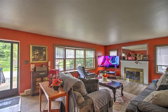 2921 Wasson Way, Decatur, IL 62521 - living area featuring plenty of natural light, a brick fireplace, and wood finished floors