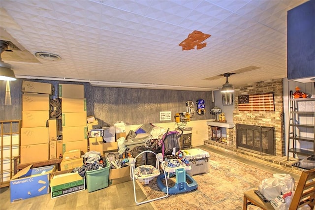 2921 Wasson Way, Decatur, IL 62521 - living room featuring wood finished floors, a brick fireplace, and wood walls