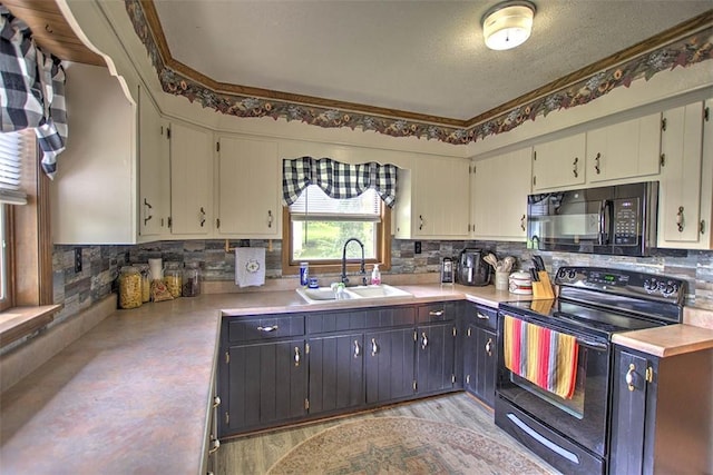 2921 Wasson Way, Decatur, IL 62521 - kitchen with black appliances, light countertops, and tasteful backsplash