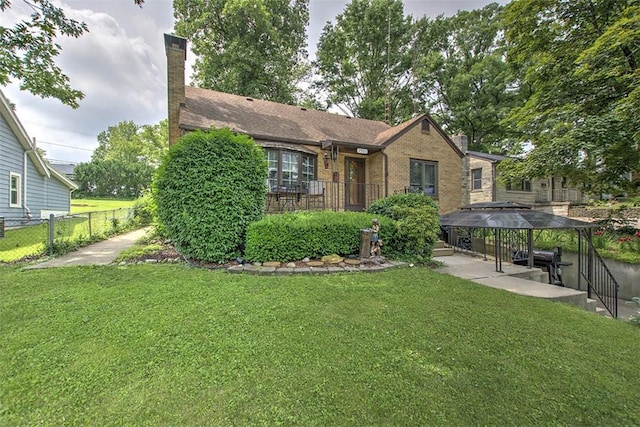 2921 Wasson Way, Decatur, IL 62521 - view of front of house featuring a chimney, brick siding, and a gazebo