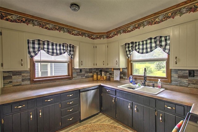 2921 Wasson Way, Decatur, IL 62521 - kitchen featuring dishwasher, decorative backsplash, light countertops, light wood-style flooring, and a textured ceiling
