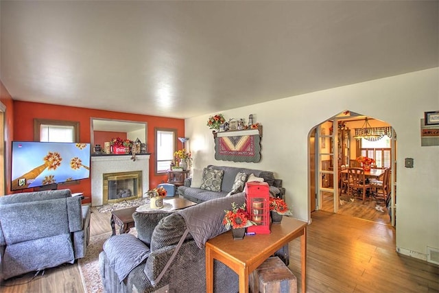 2921 Wasson Way, Decatur, IL 62521 - living area with arched walkways, a glass covered fireplace, and wood finished floors