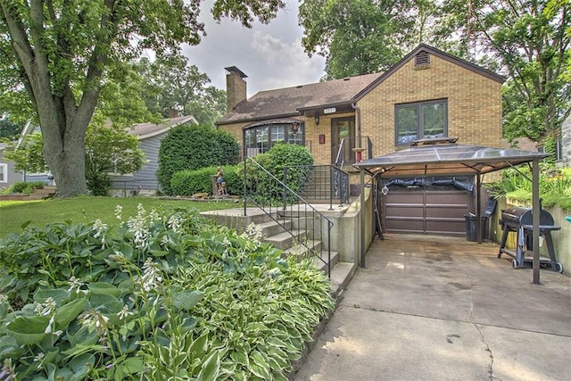 2921 Wasson Way, Decatur, IL 62521 - view of front of house with brick siding, a chimney, concrete driveway, and a garage