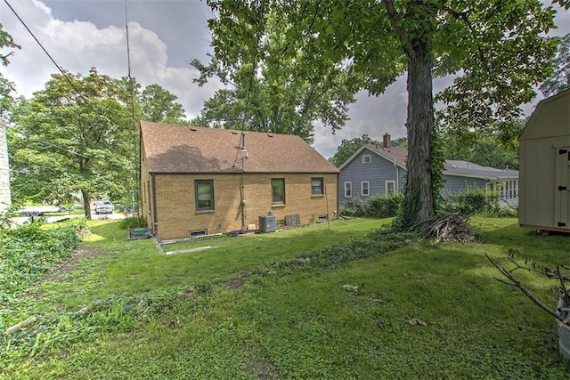 2921 Wasson Way, Decatur, IL 62521 - back of house featuring brick siding and a yard