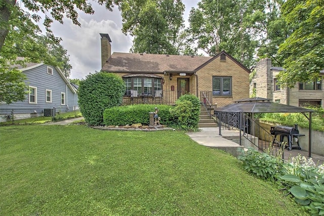 2921 Wasson Way, Decatur, IL 62521 - view of front facade featuring brick siding, a chimney, a gazebo, and a patio