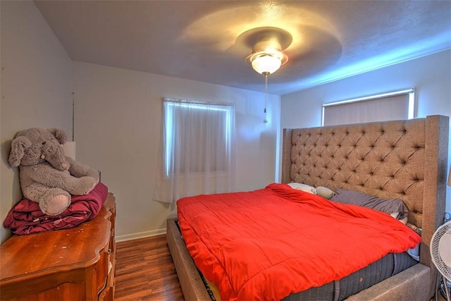 bedroom with ceiling fan and dark wood-type flooring