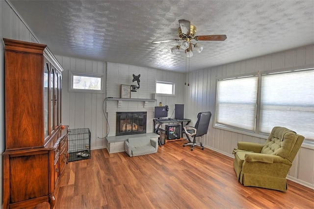 sitting room featuring ceiling fan, a healthy amount of sunlight, and hardwood / wood-style floors